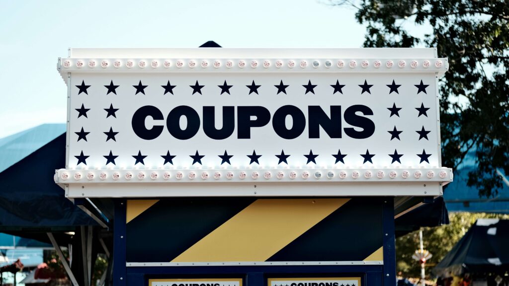 Sign with 'Coupons' written in bold, symbolizing discount offers, deals, and savings opportunities for consumers