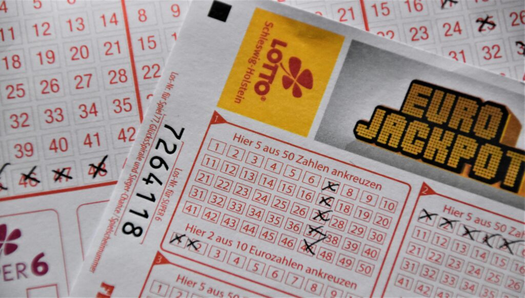 Close-up of lottery tickets with marked numbers, representing gambling, lottery jackpots, and the odds of winning big